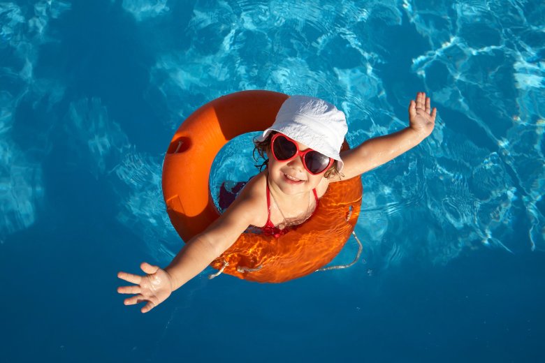 Overhead of young girl in orange life preserver Overhead of young girl in orange life preserver